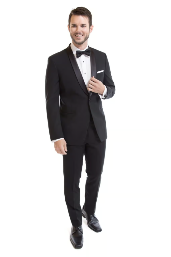 Man in black tuxedo holding a drink on a white background