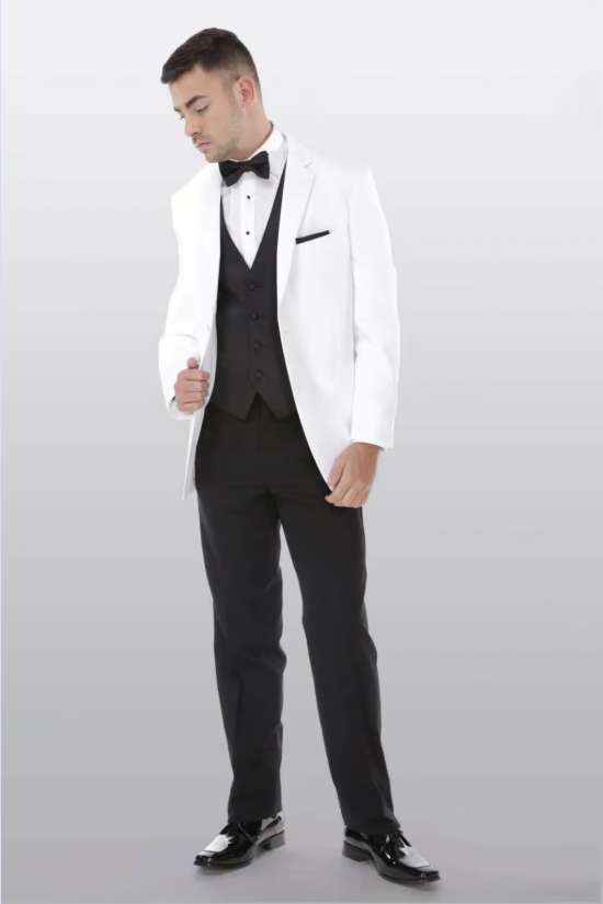 Man in a white tuxedo jacket and black suit standing against a light gray background.
