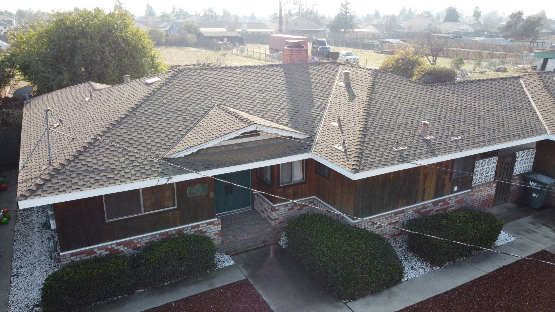 An aerial view of a house with a car parked in front of it.