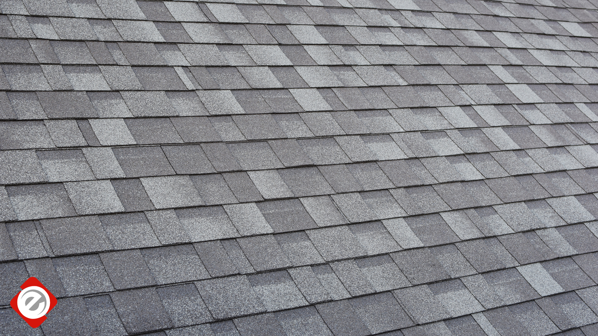 Gray asphalt shingle roof with a slight angle.