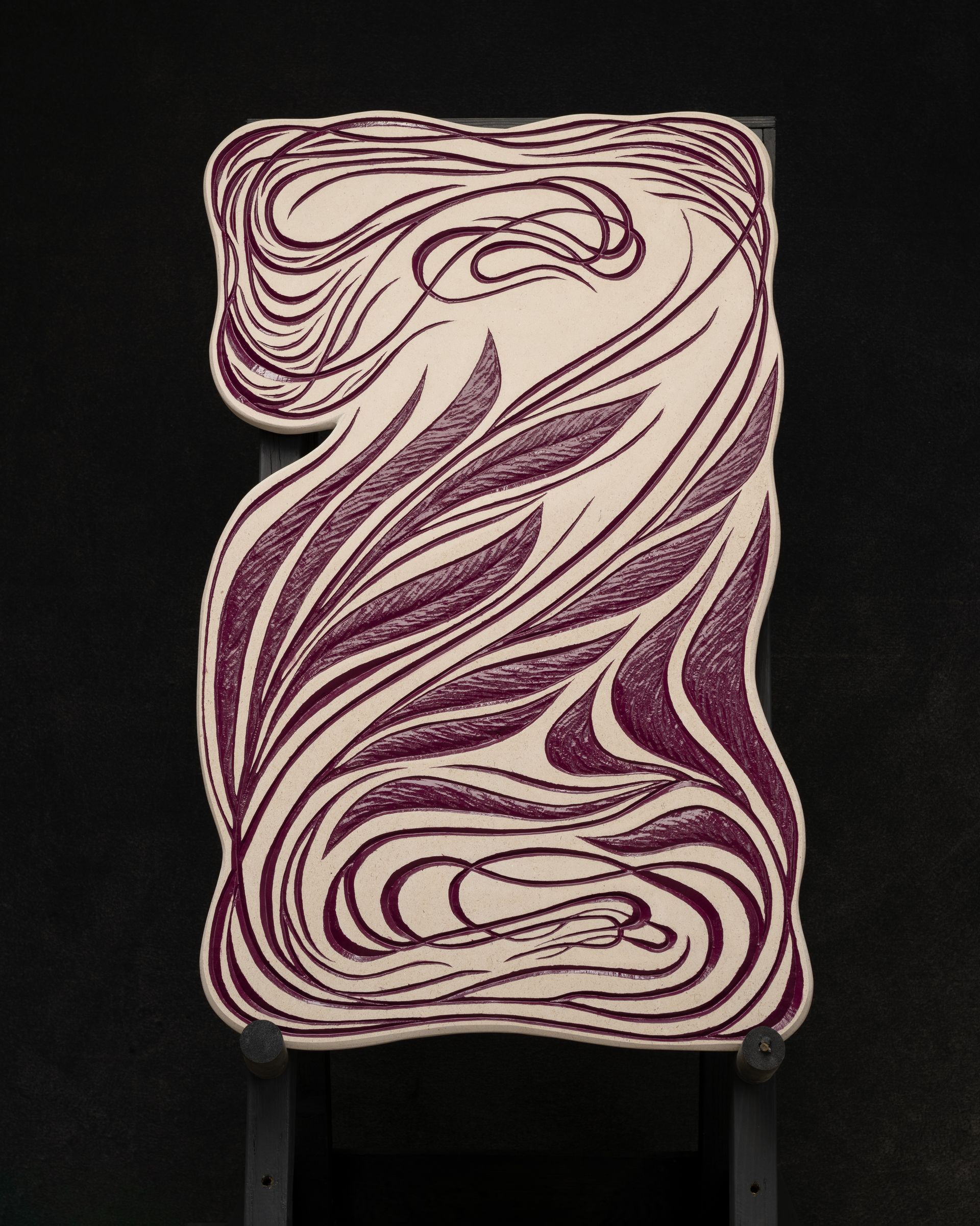 A purple and white swirl on a black surface