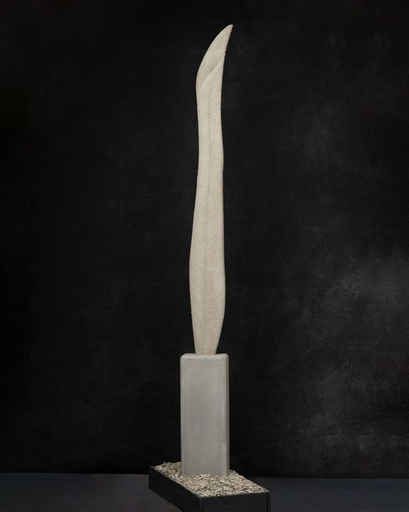 A tall white sculpture carved in stone