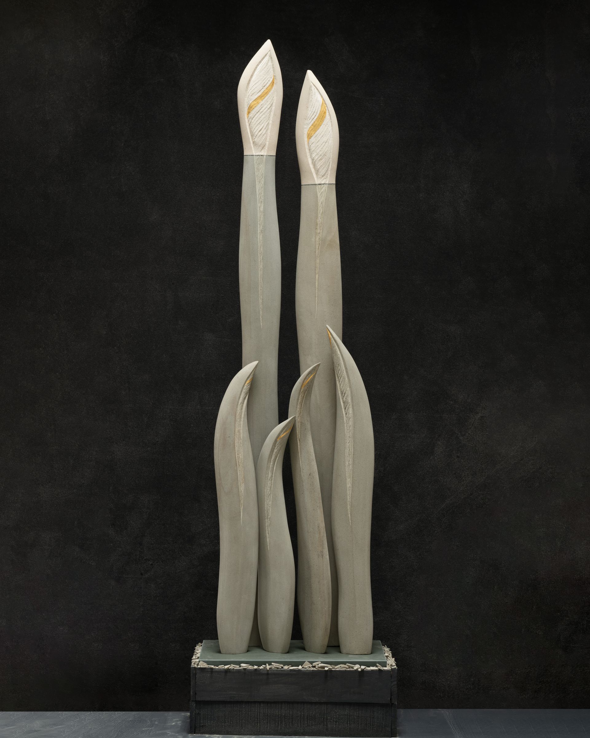 A statue of three candles on a black background