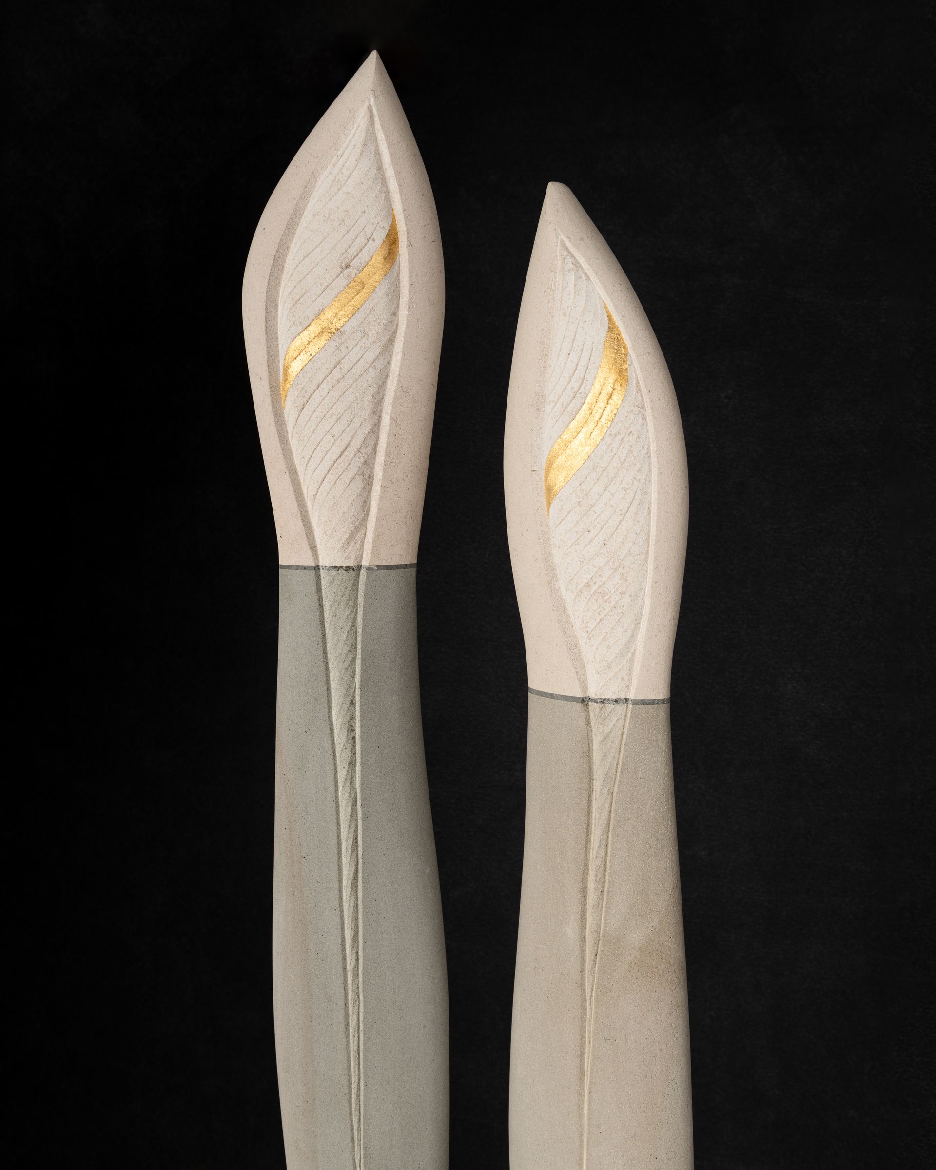 A statue of three candles on a black background
