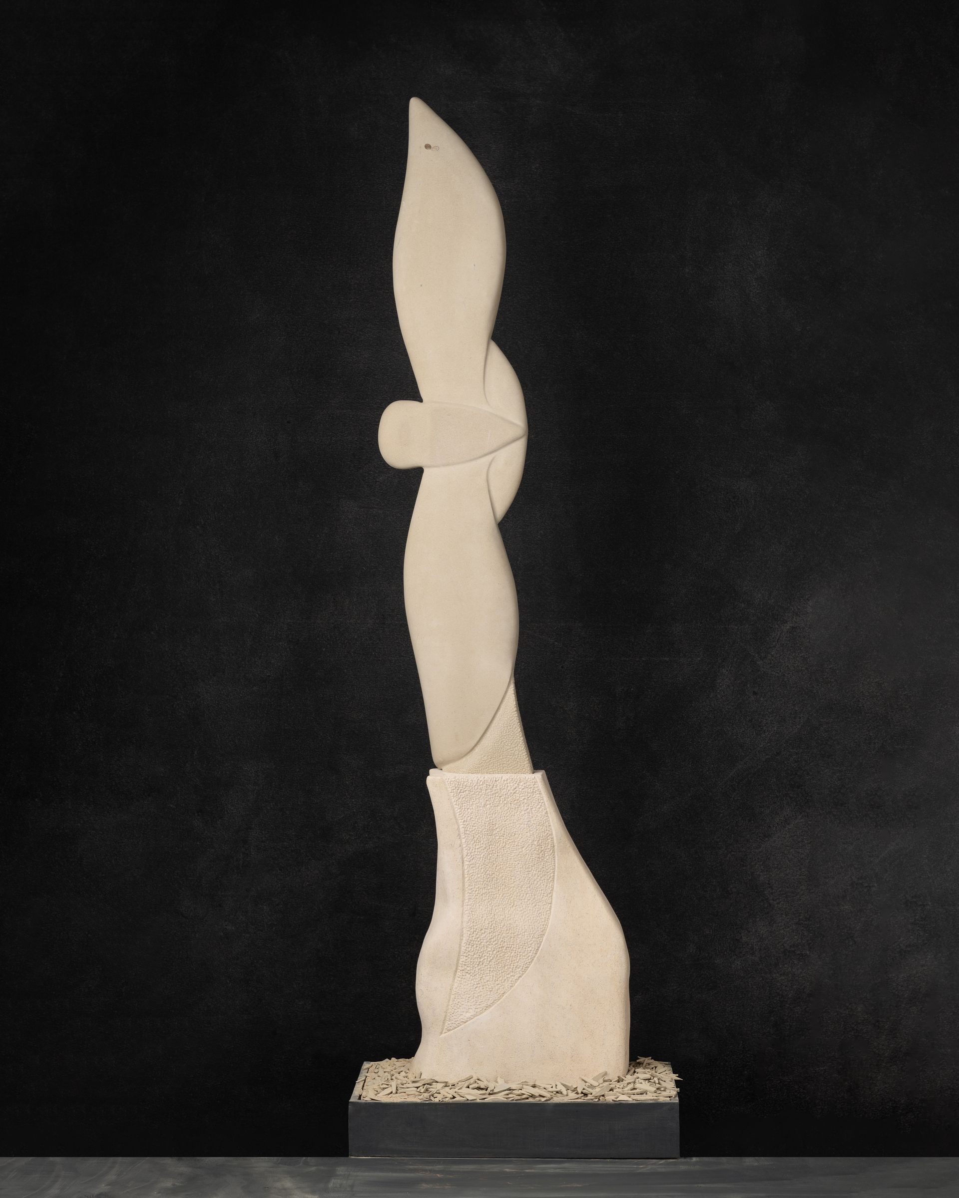 A statue with a black background is sitting on a table