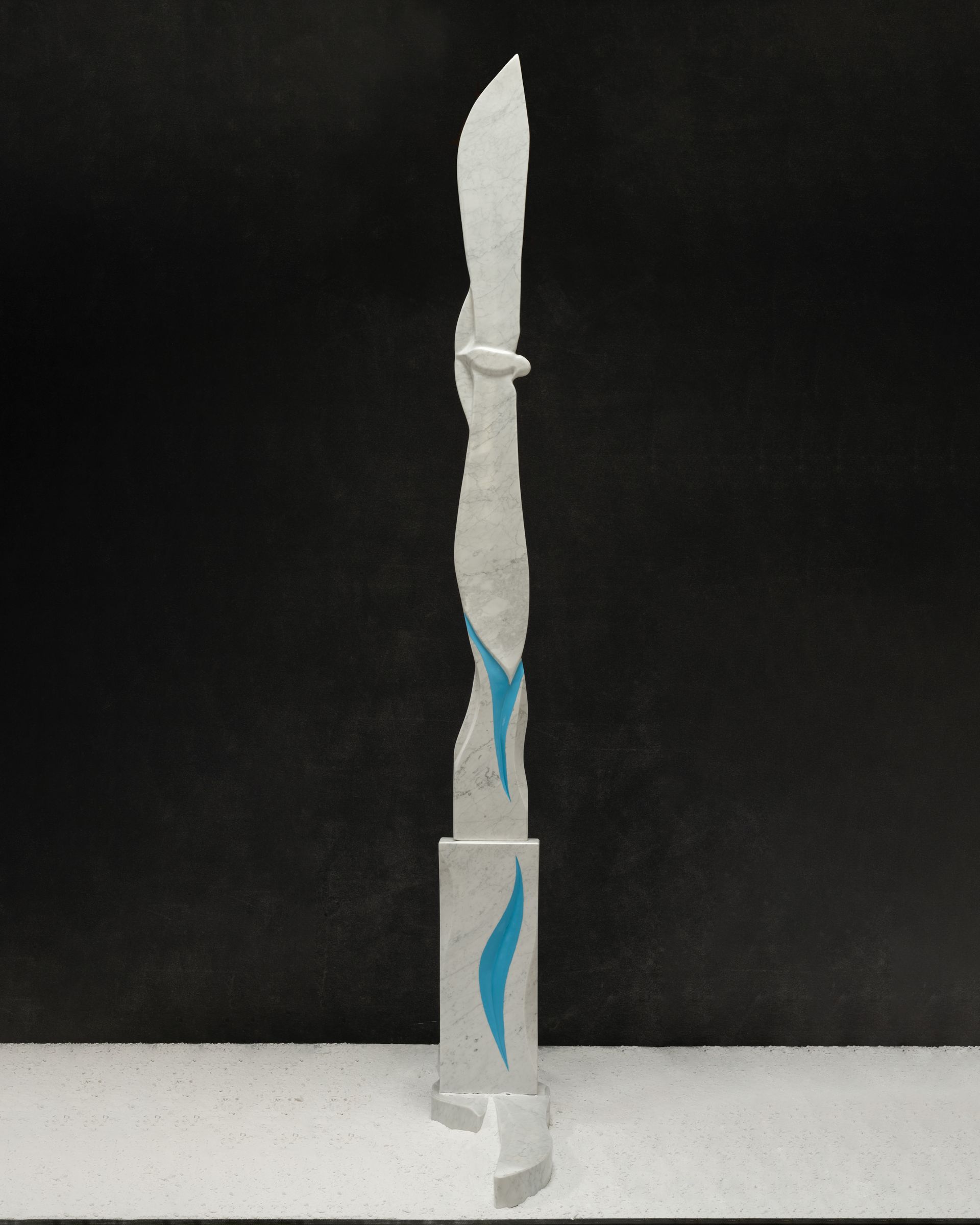 Nick Rugg is standing next to a large white sculpture