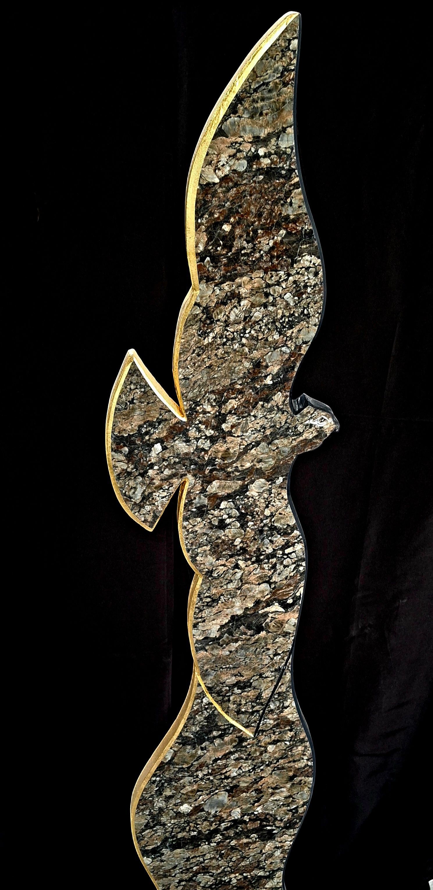 Abstract gold and black metallic sculpture silhouette on a dark background