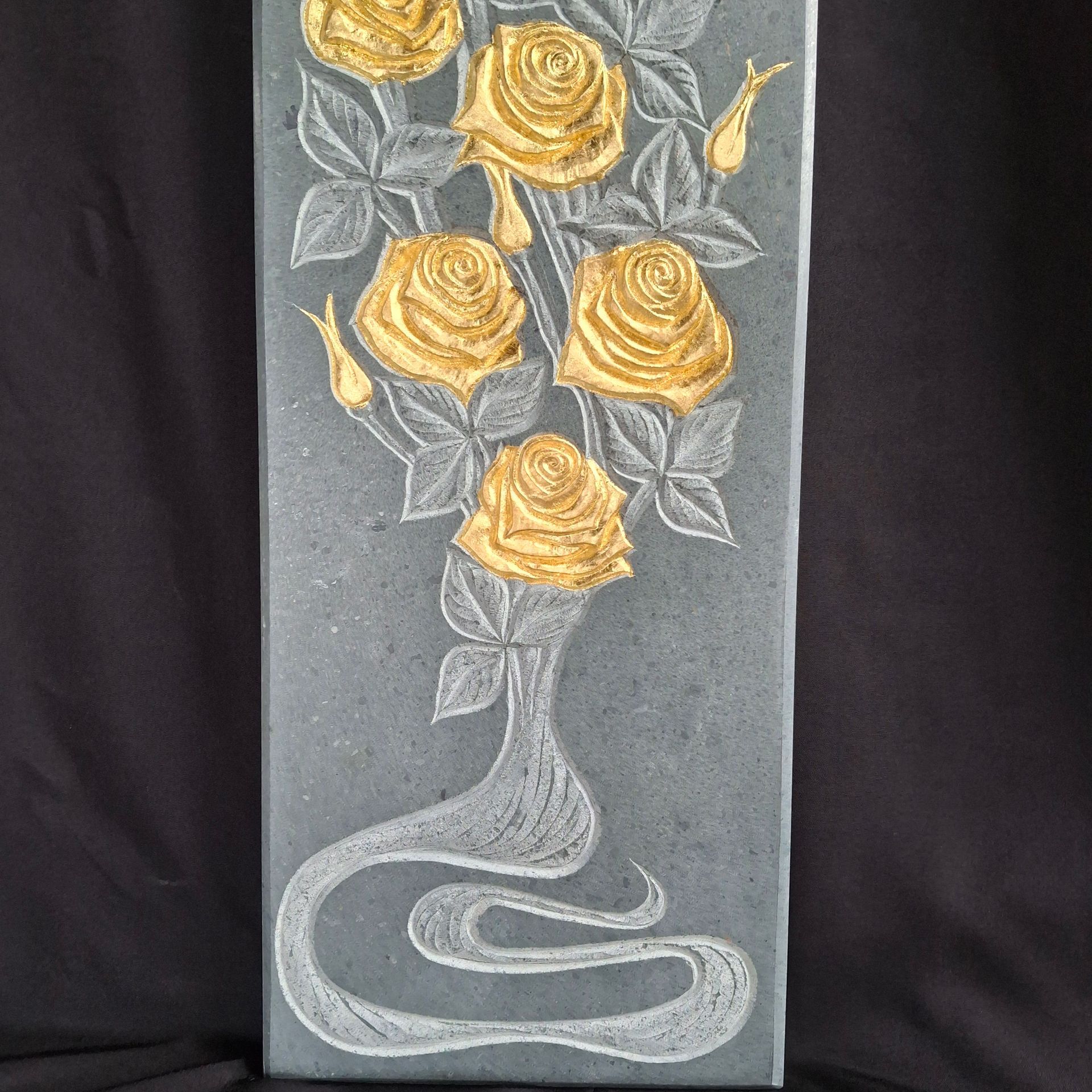 A painting of gold roses on a black background