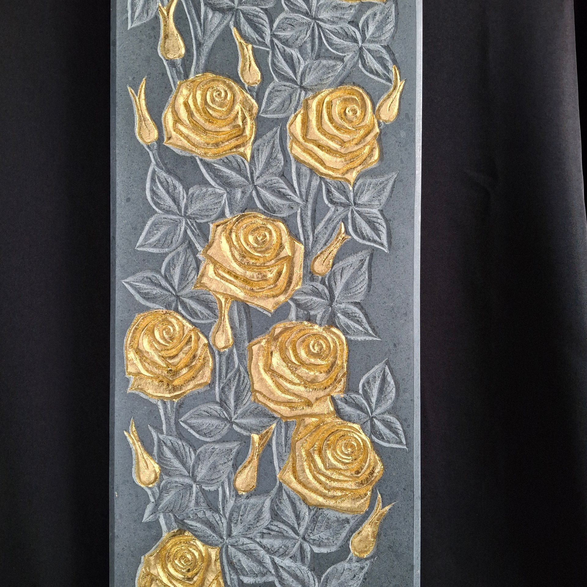 A painting of gold roses on a black background