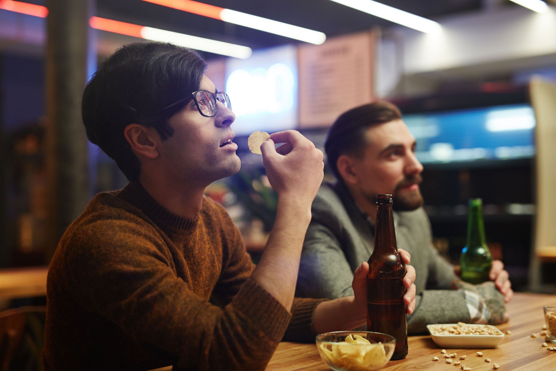 Two men sitting next to each other