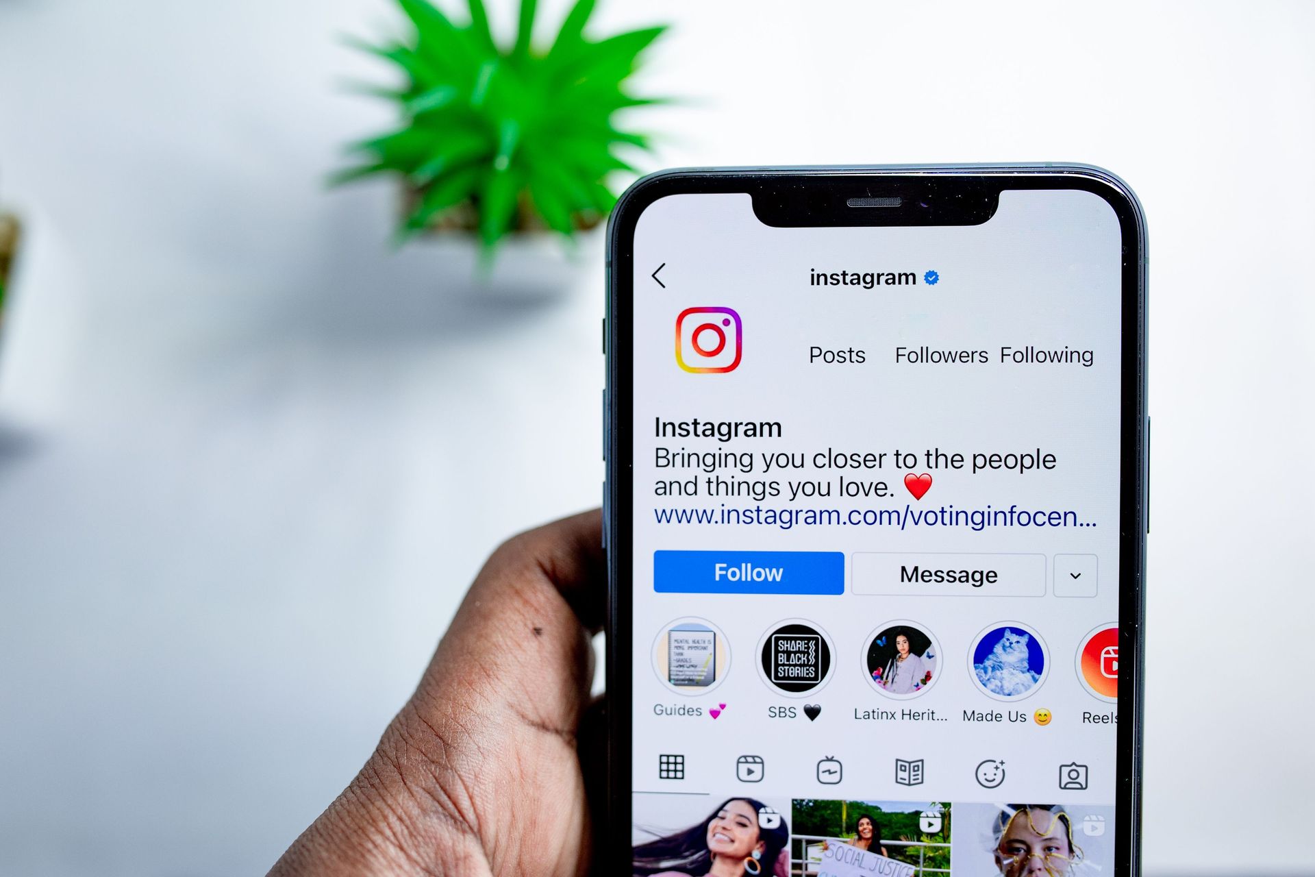 hand holding a phone open to Instagram