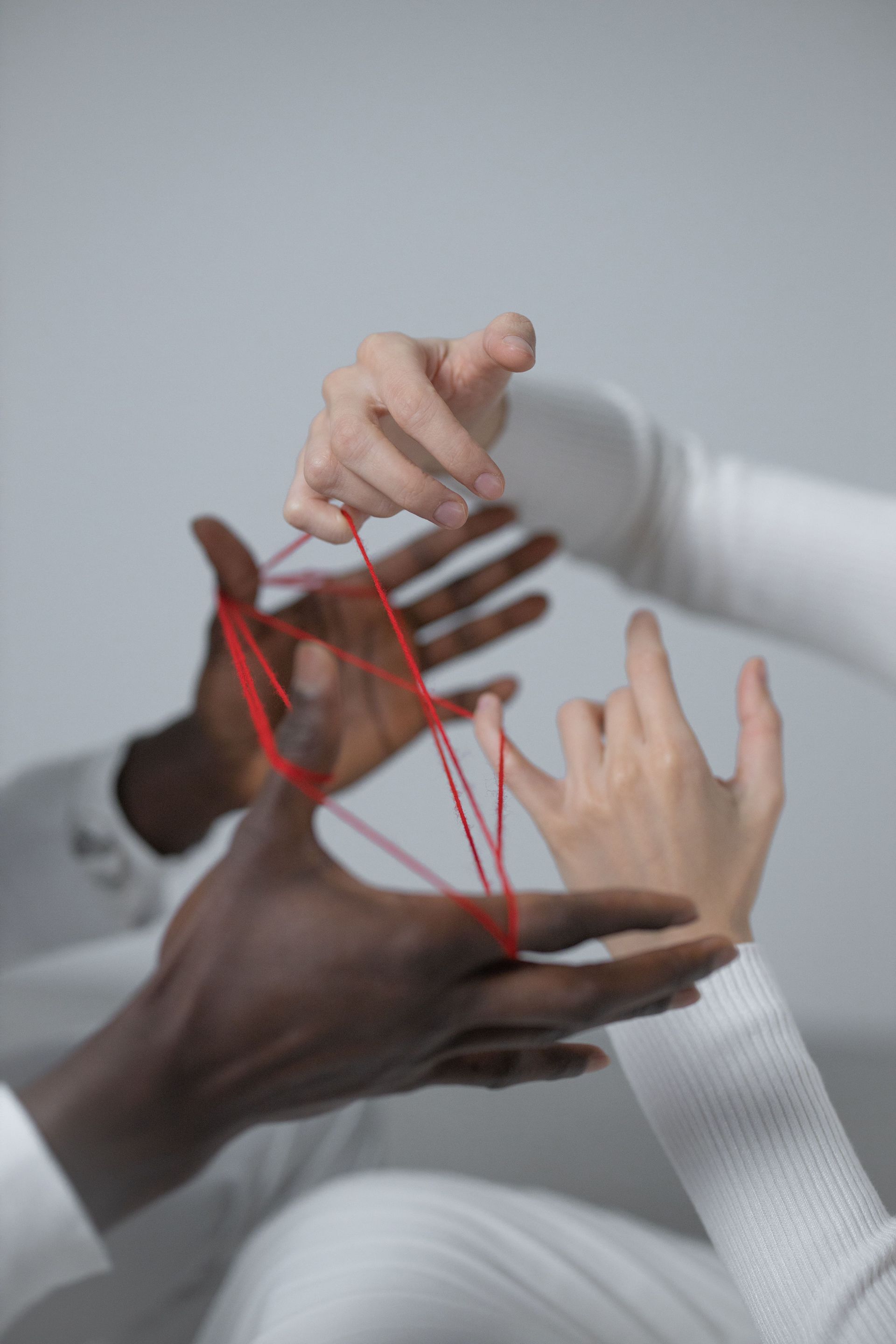 Hands connected with red yarn