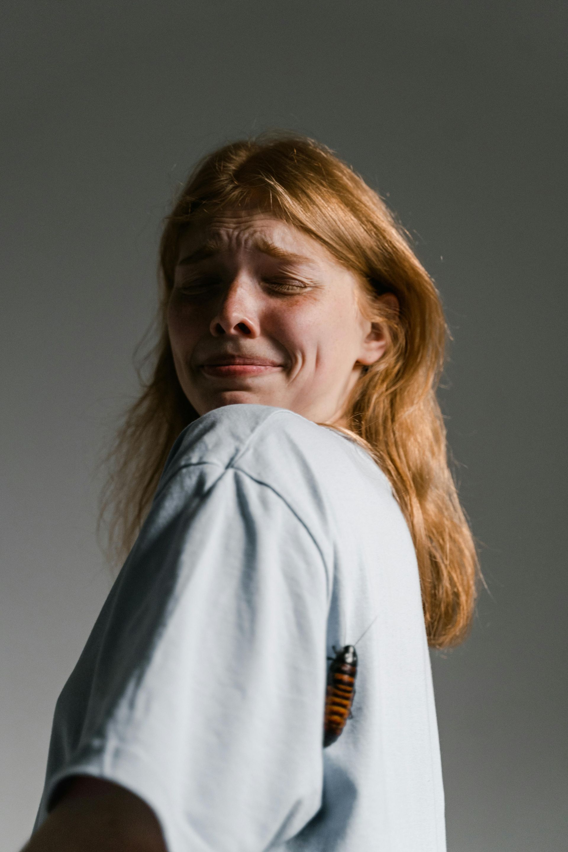 A woman with blonde hair looking uncomfortable on camera