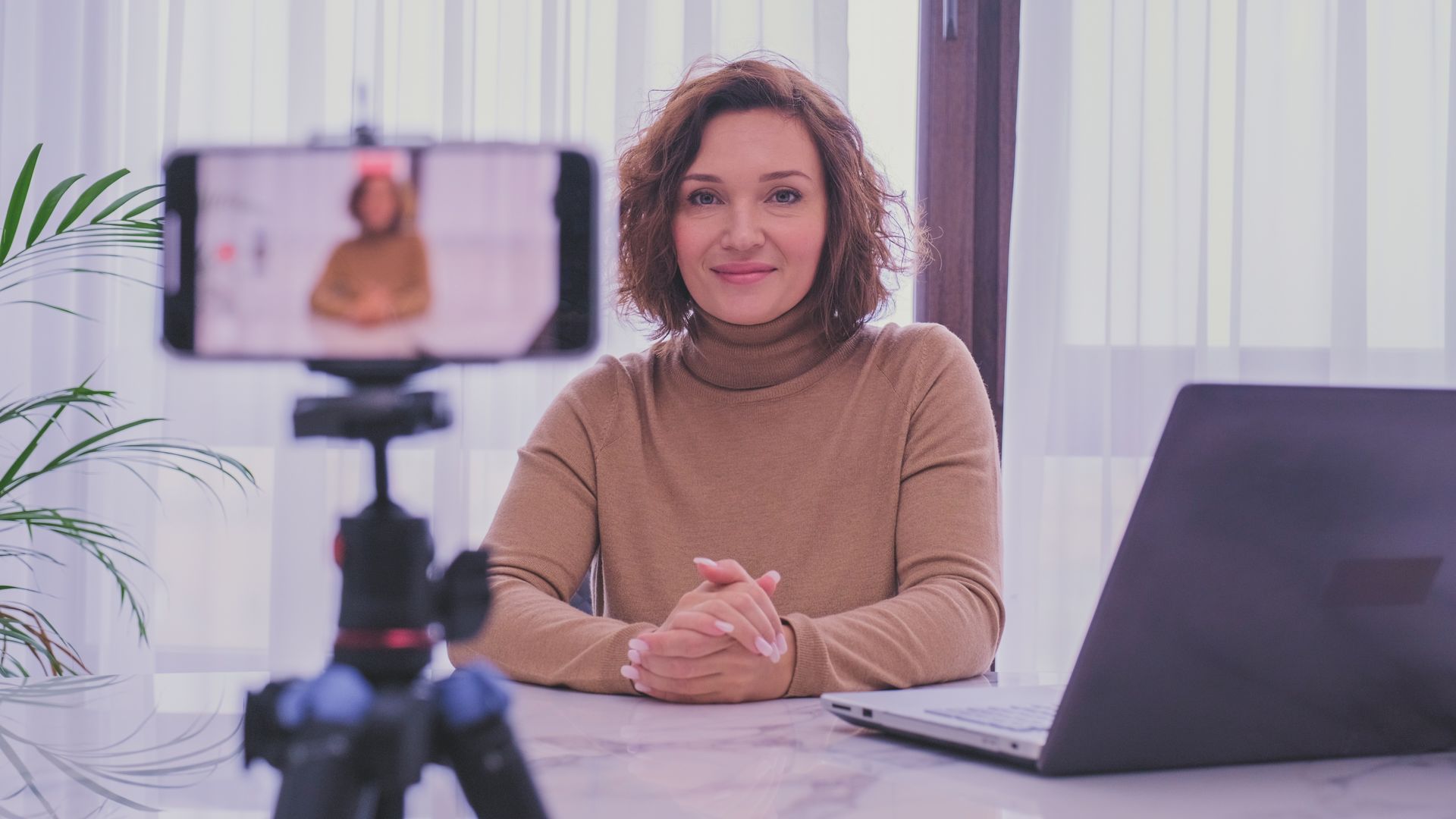 woman filming herself with her phone