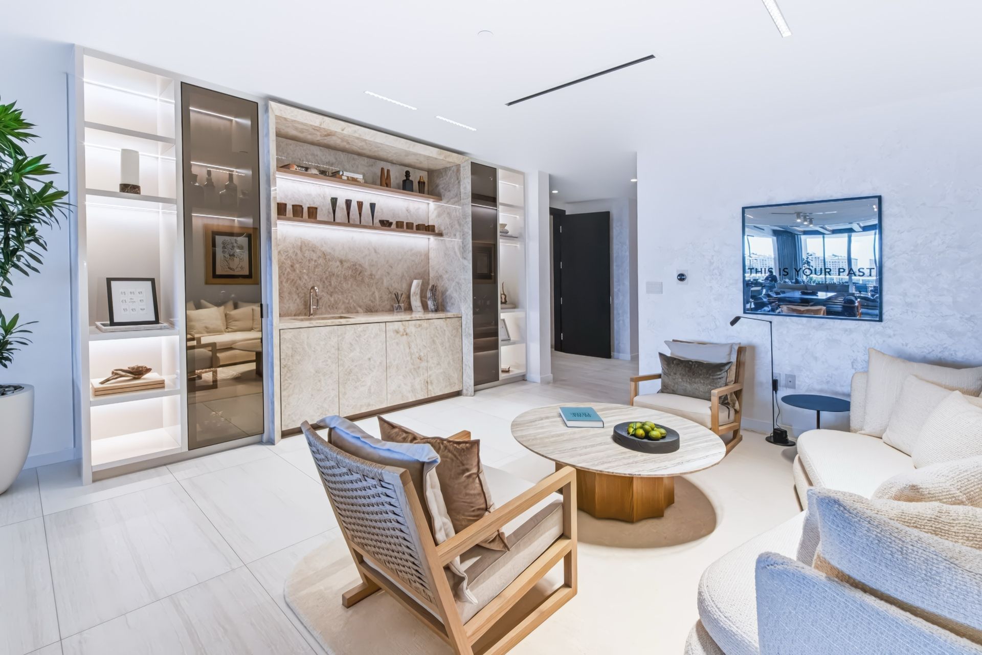 Lounge and bar with Taj Mahal stone and illuminated cabinetry, Finn Residence at Alina Residences, Boca Raton