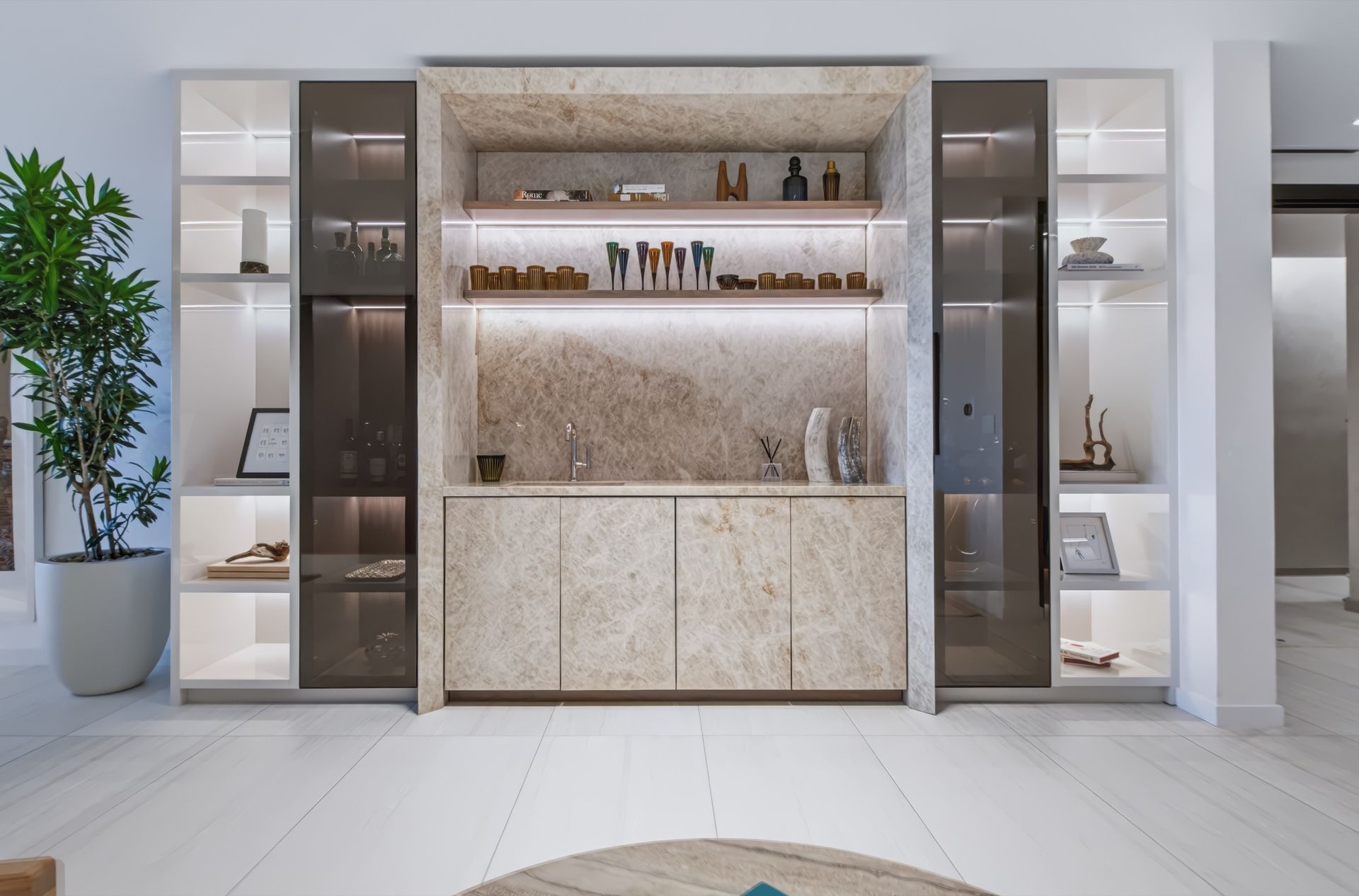 Lounge and bar with Taj Mahal stone and illuminated cabinetry, Finn Residence at Alina Residences, Boca Raton