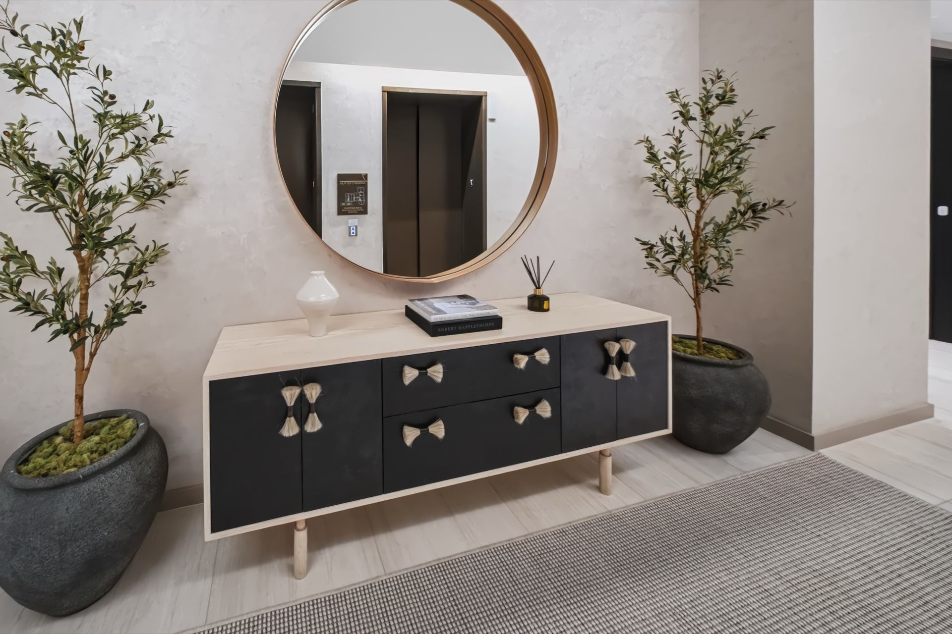 Elevator landing with custom console and round mirror, Finn Residence at Alina Residences, Boca Raton
