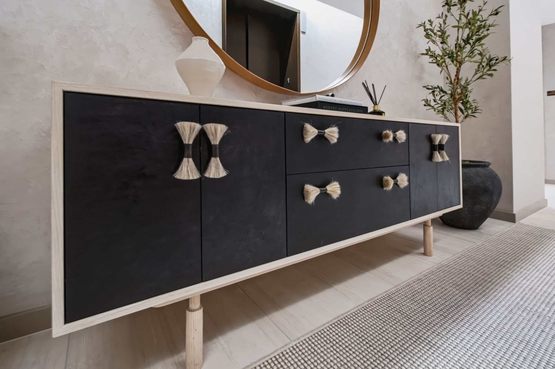 Elevator landing with custom console and round mirror, Finn Residence at Alina Residences, Boca Raton
