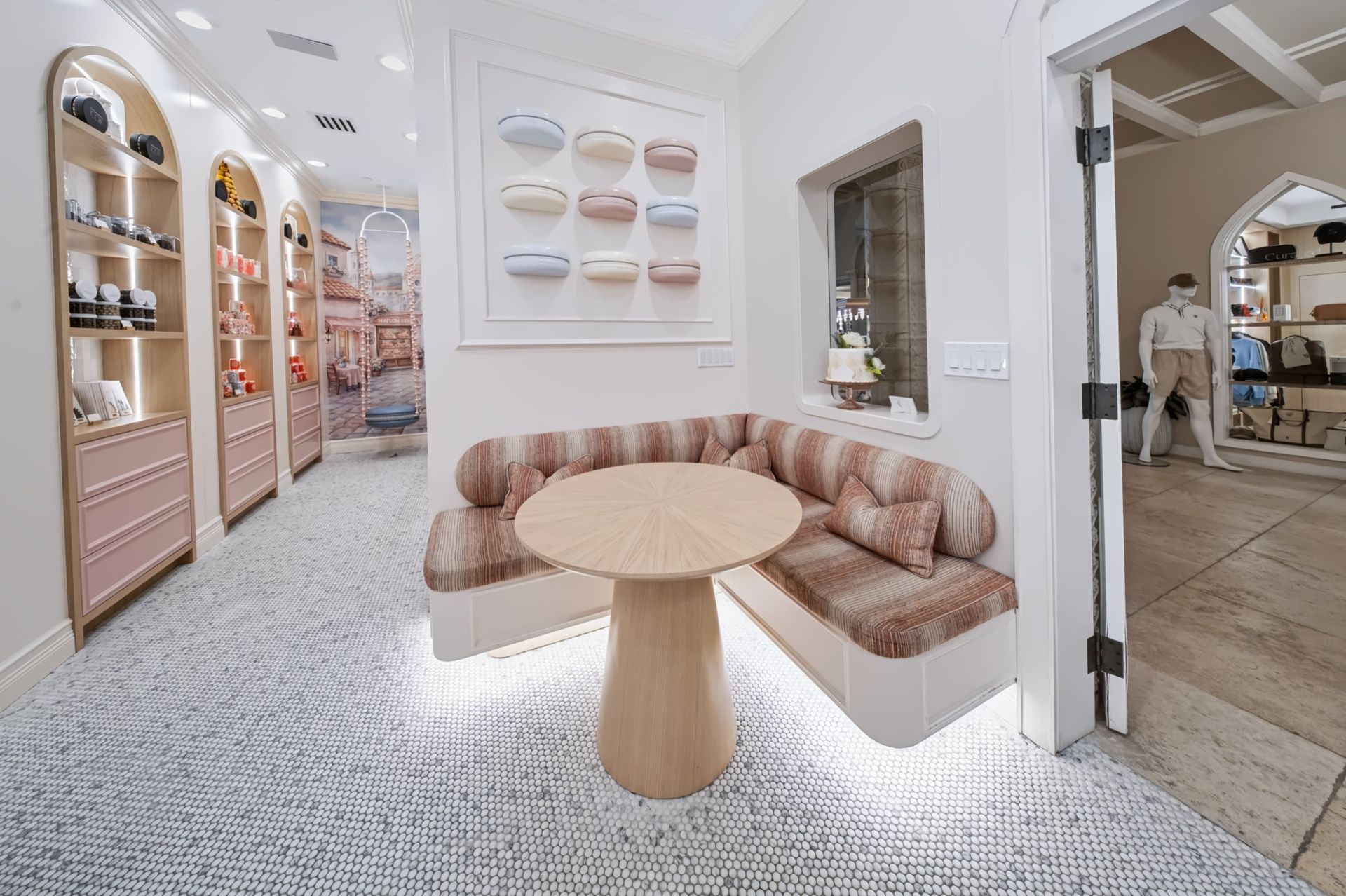 Seating nook with sculptural white oak table and macaron wall art, Maison Rose at The Boca Raton