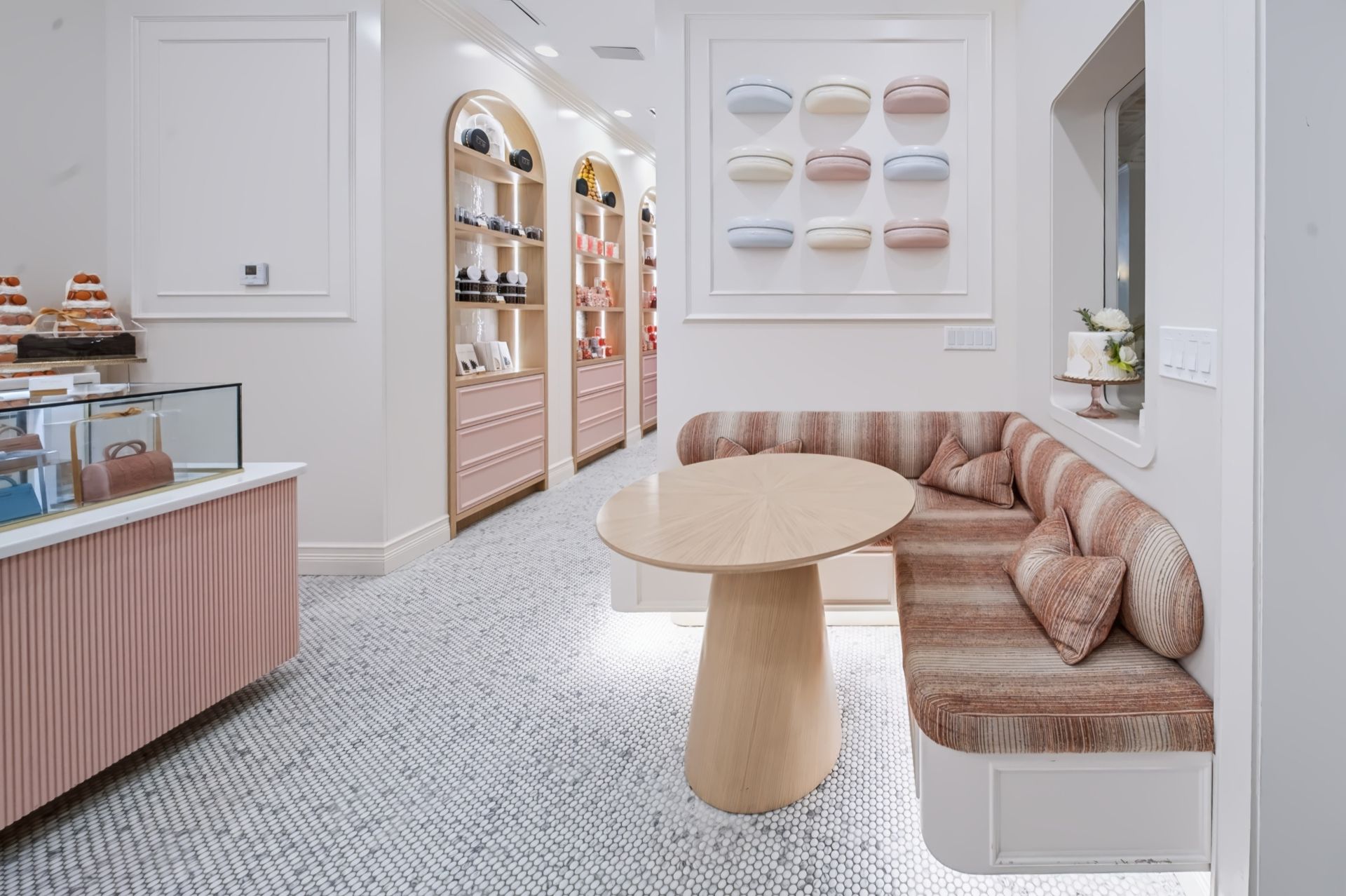 Seating nook with sculptural white oak table and macaron wall art, Maison Rose at The Boca Raton
