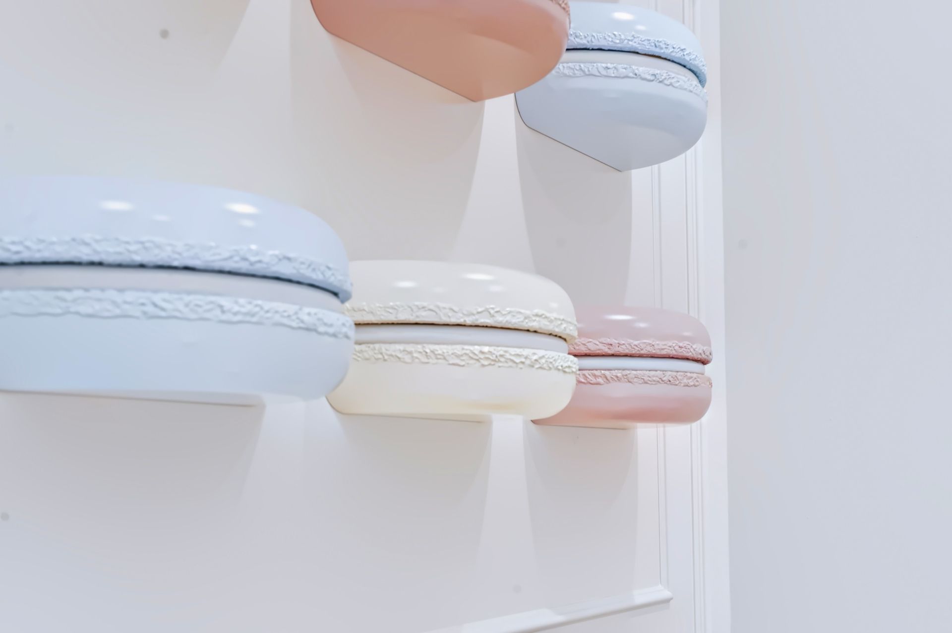 Seating nook with sculptural white oak table and macaron wall art, Maison Rose at The Boca Raton