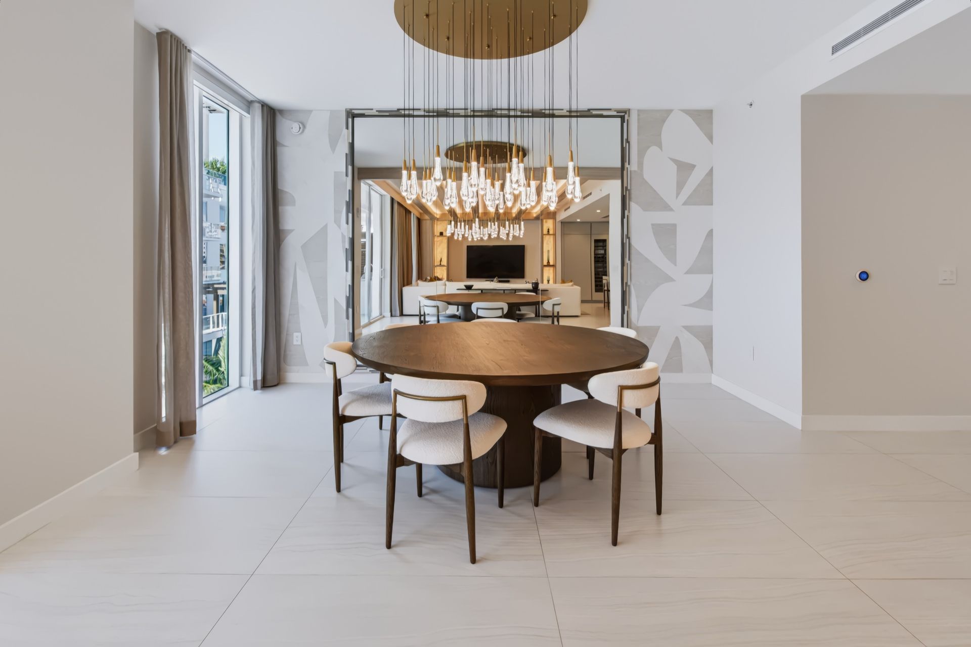 Dining room with oversized custom mirror and crystal chandelier, Streinger Residence at Alina Residences, Boca Raton