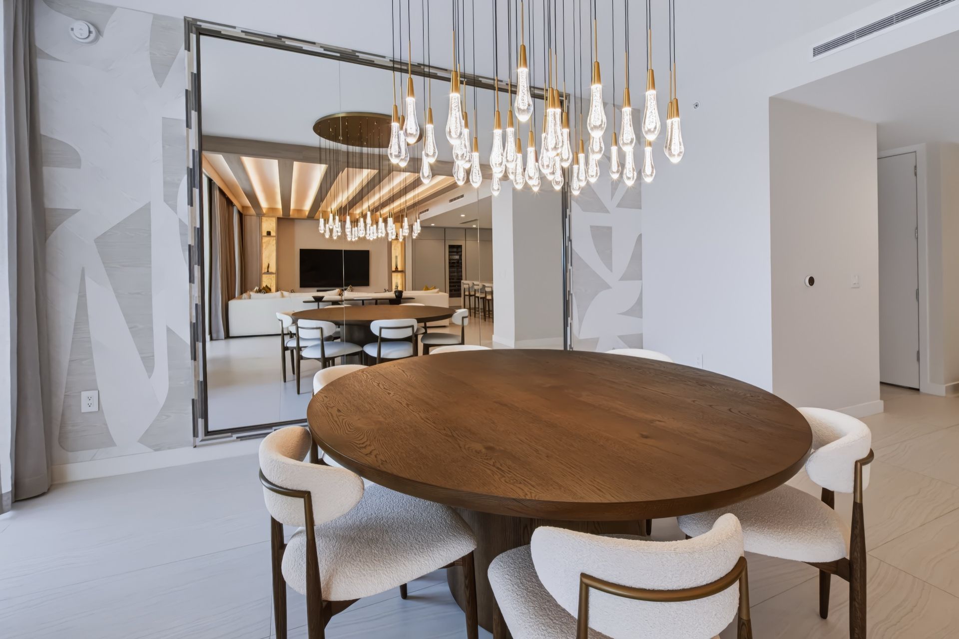 Dining room with oversized custom mirror and crystal chandelier, Streinger Residence at Alina Residences, Boca Raton