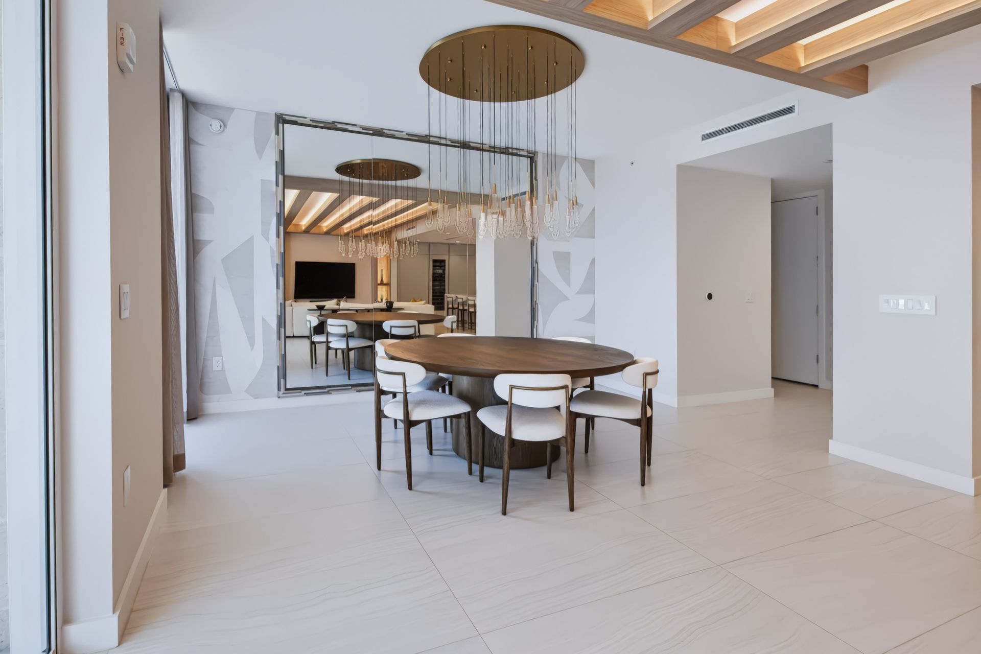 Dining room with oversized custom mirror and crystal chandelier, Streinger Residence at Alina Residences, Boca Raton