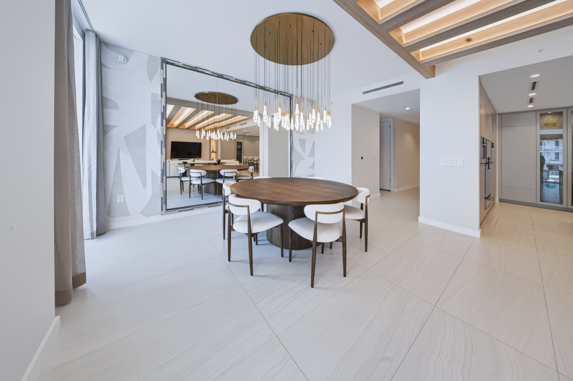 Dining room with oversized custom mirror and crystal chandelier, Streinger Residence at Alina Residences, Boca Raton
