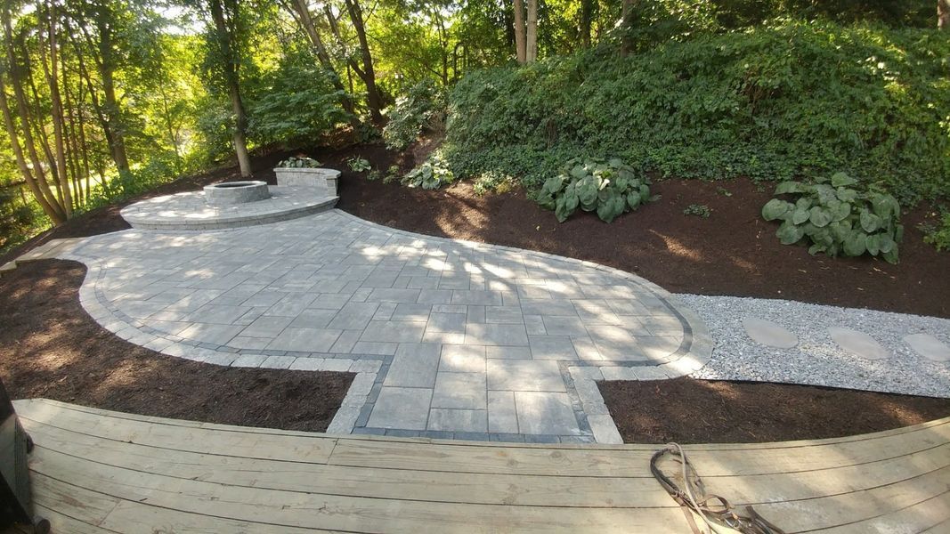 There is a patio in the middle of the woods.