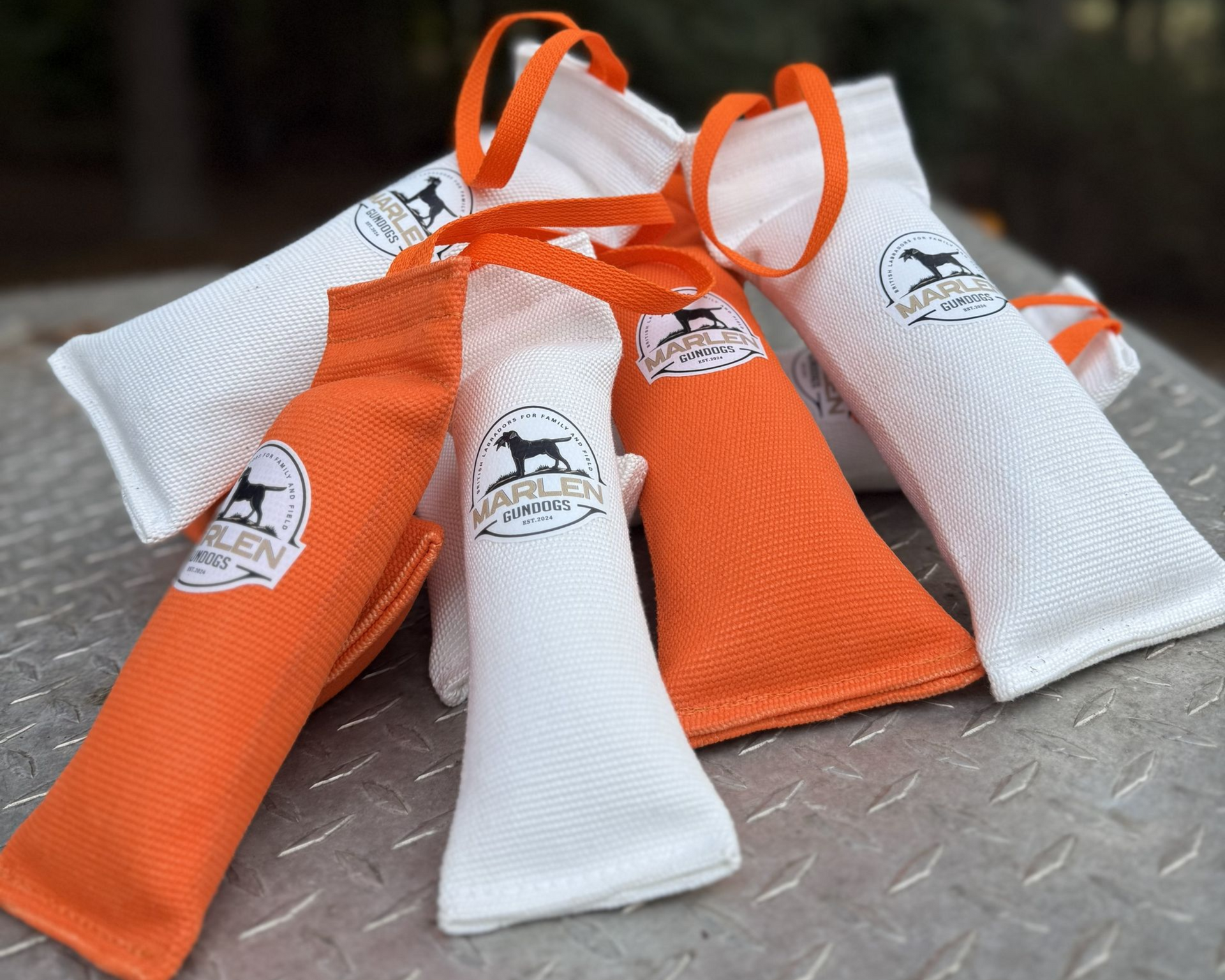 A pile of orange and white dog training dummies with