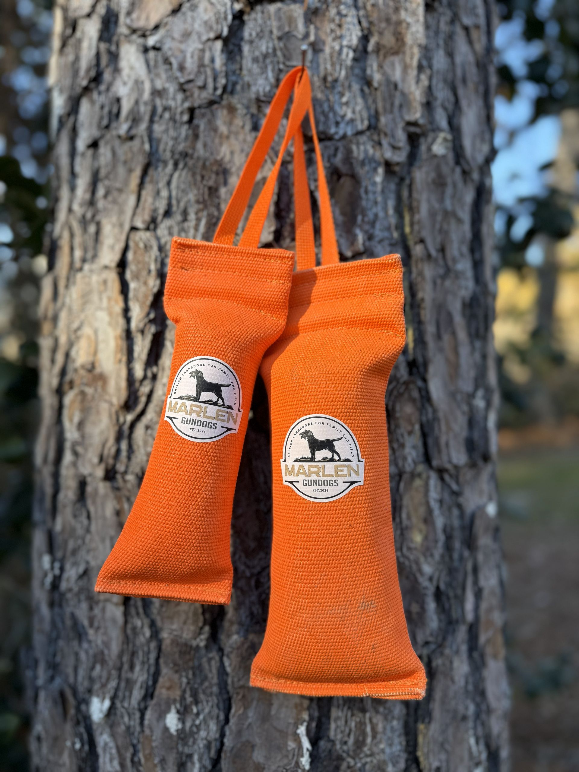 A pile of orange and white dog training dummies with