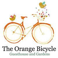 Orange bicycle logo with bird and fruit, reading “The Orange Bicycle Guesthouse and Gardens”