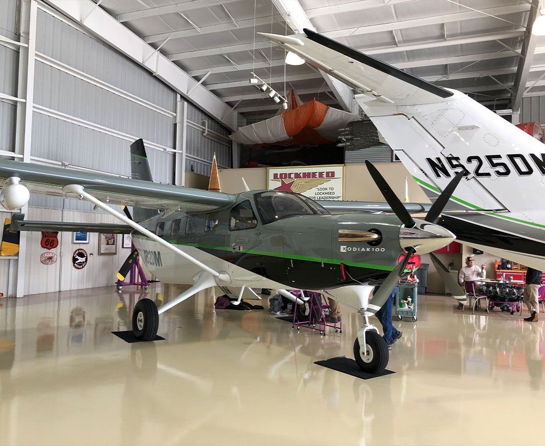 A small propeller plane is parked in a hangar.