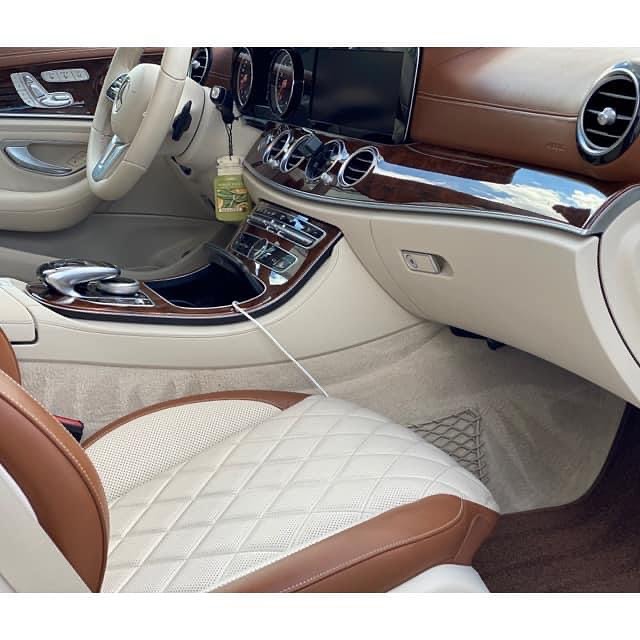 The interior of a car with brown and white seats