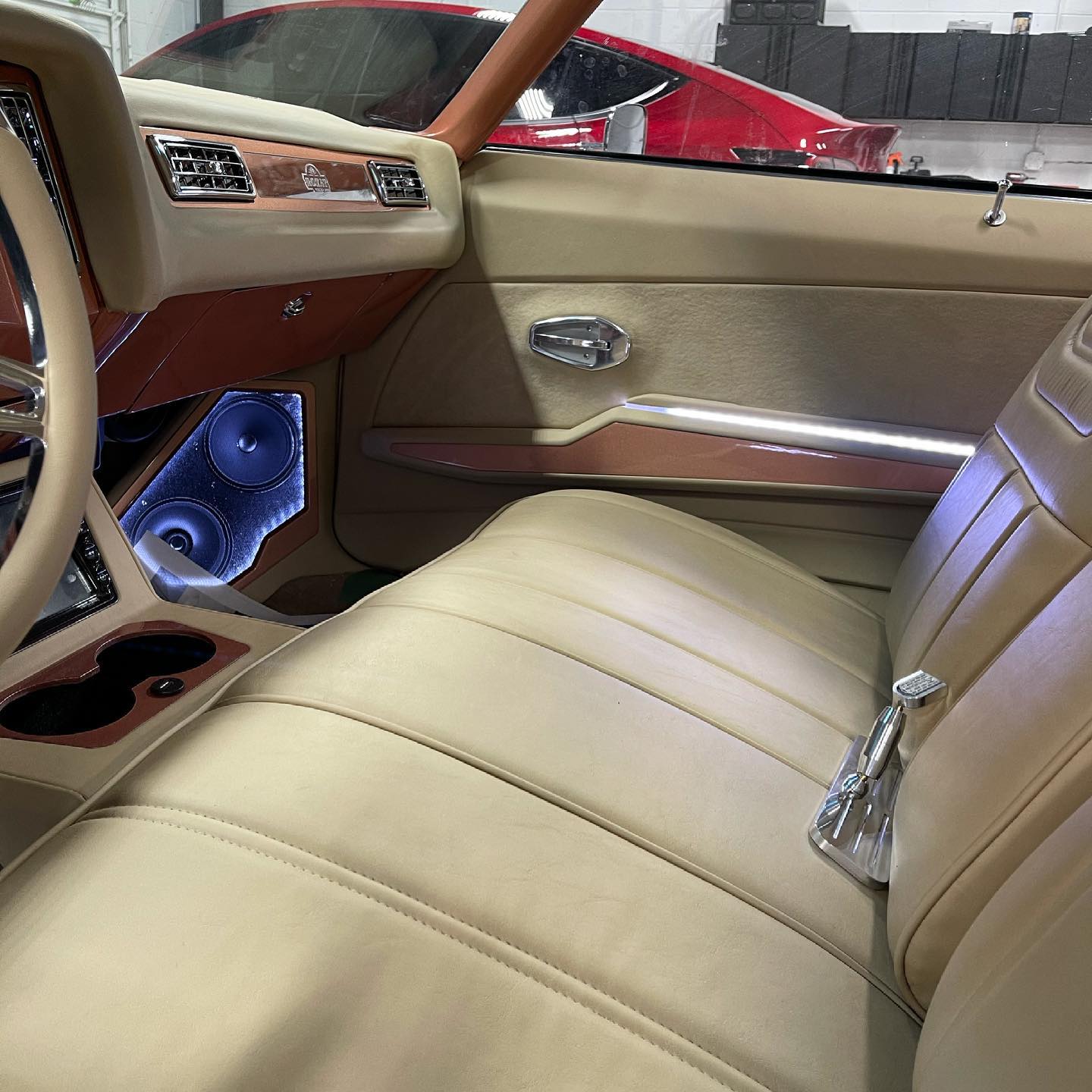 The inside of a car with tan leather seats and a steering wheel