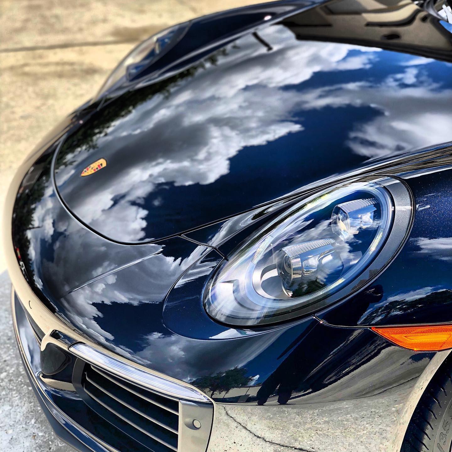 A close up of the front of a blue sports car