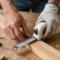 Hands measuring wood