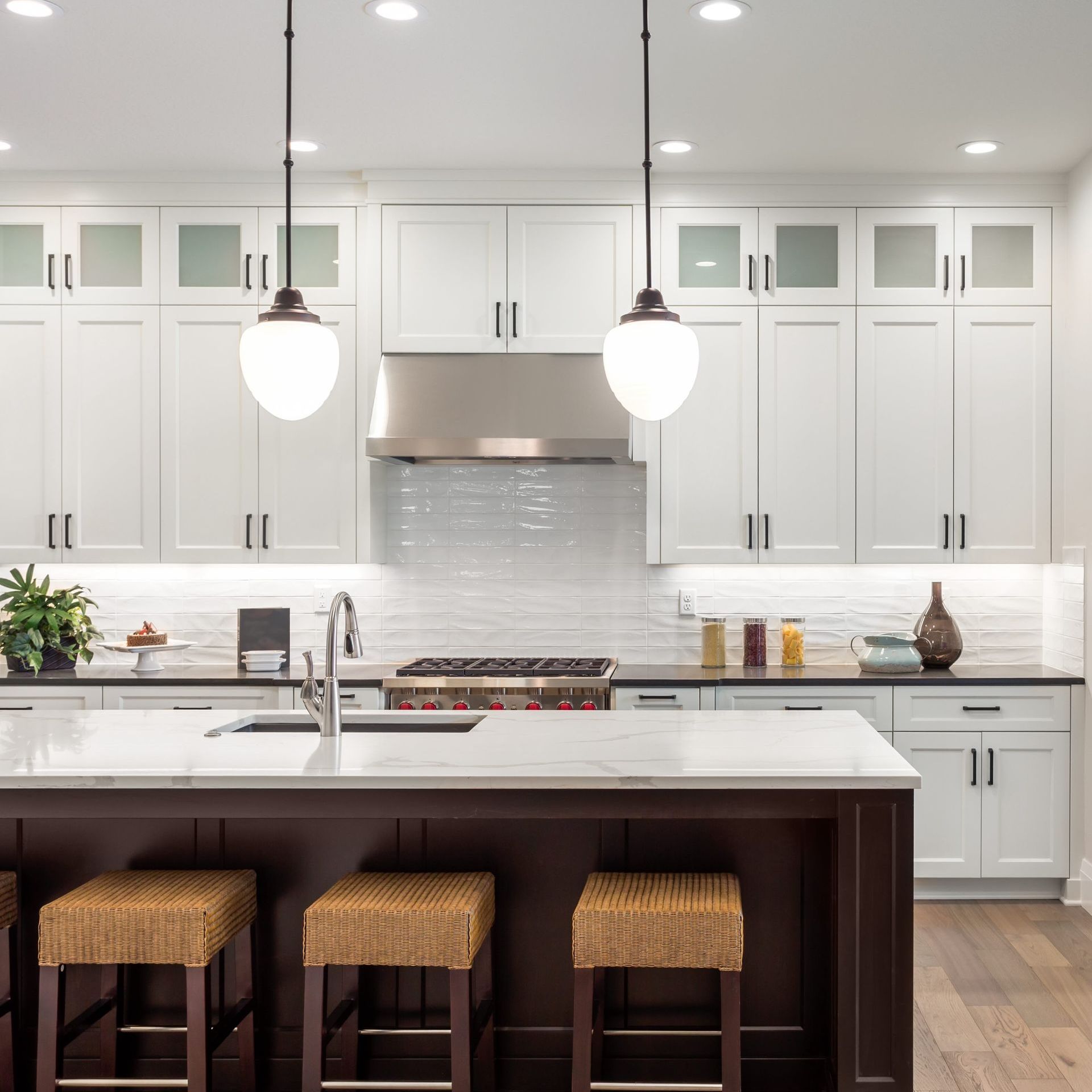 a kitchen with a large island and stools