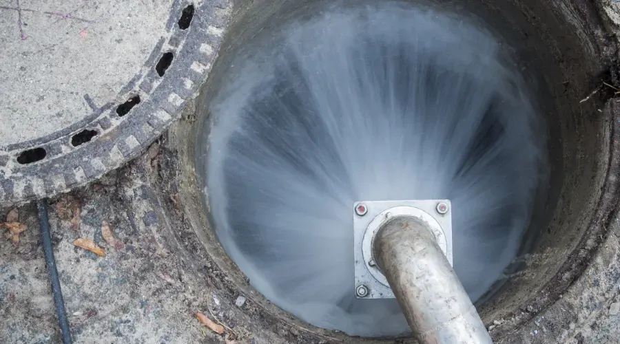 a manhole cover is open and water is coming out of it