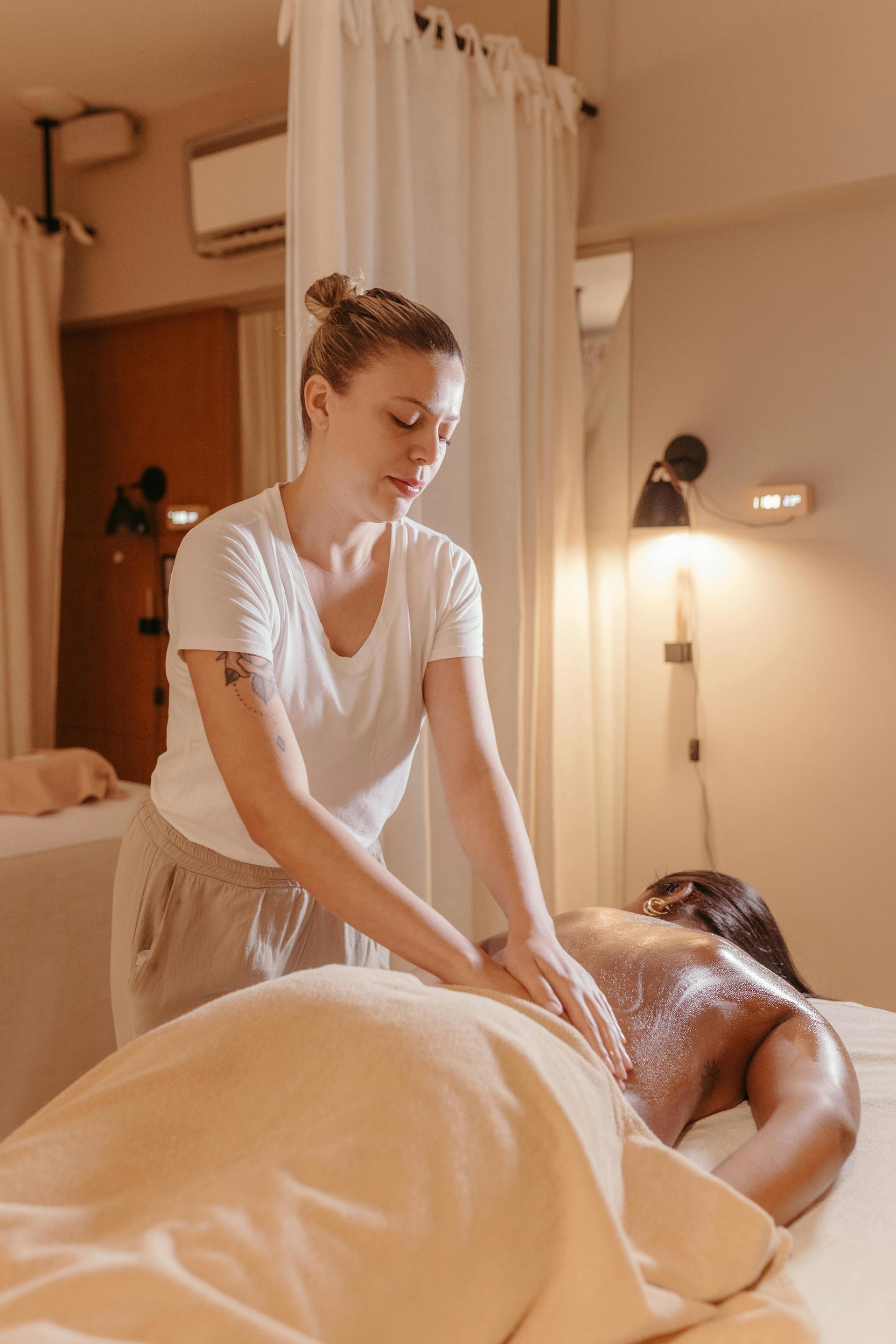 Massage Therapist Giving a Back Treatment in a Spa Room — Leela Thai Massage & Spa in Newtown, QLD