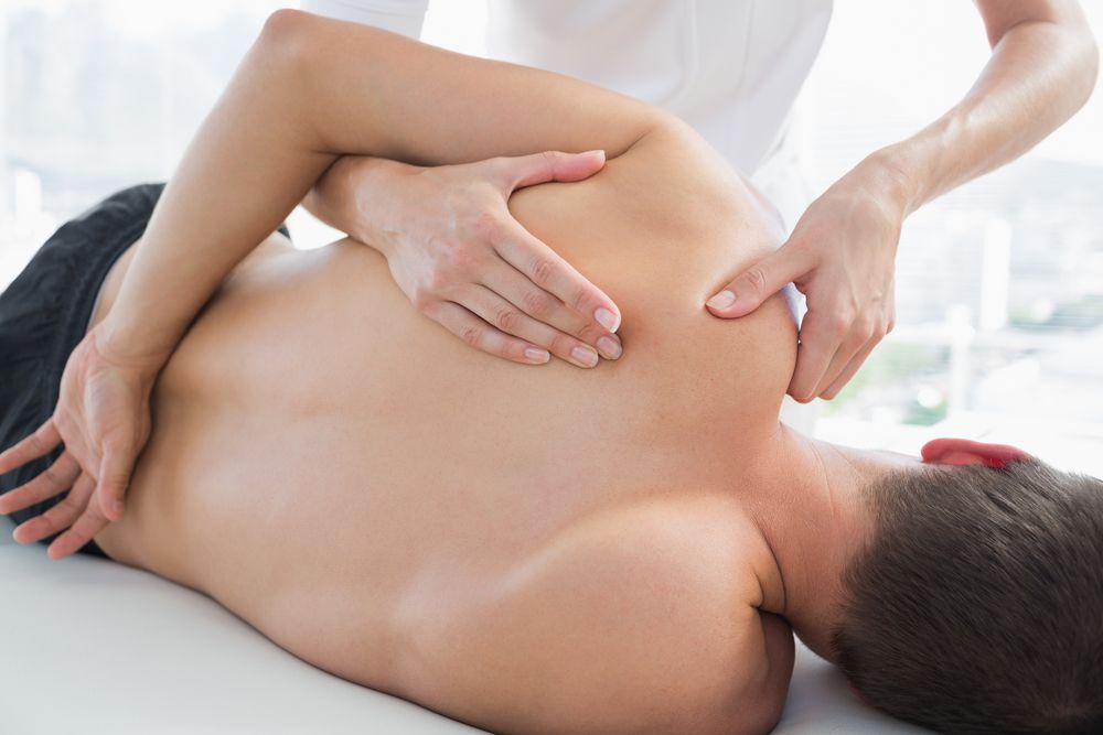 Person Receiving Shoulder Massage on a Massage Table — Leela Thai Massage & Spa in Newtown, QLD