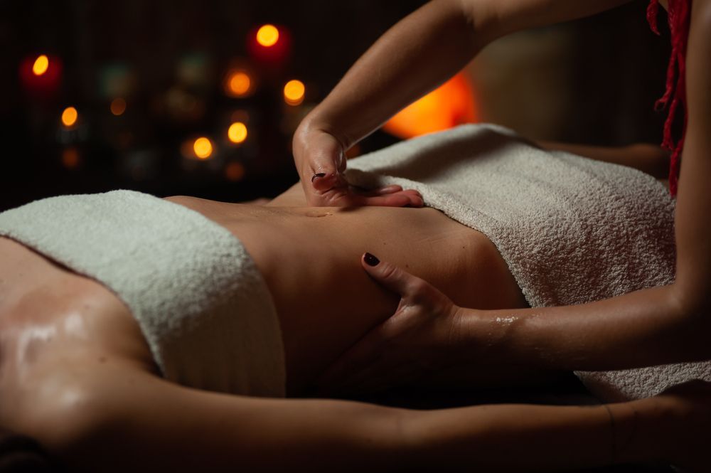Hands Massaging a Person's Abdomen — Leela Thai Massage & Spa in Newtown, QLD
