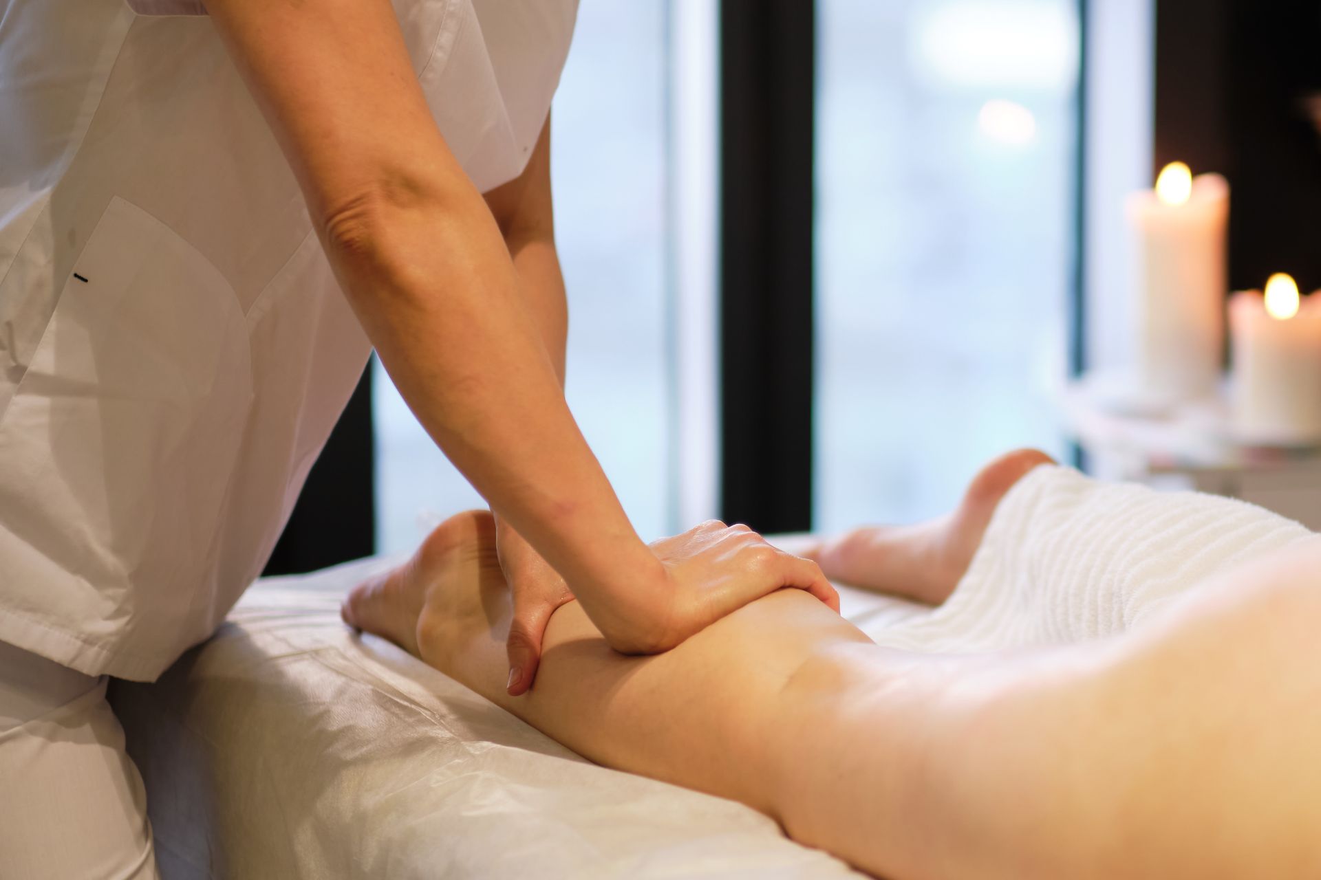 Person Receiving Leg Massage at a Spa, With a Therapist's Hand on the Calf — Leela Thai Massage & Spa in Newtown, QLD