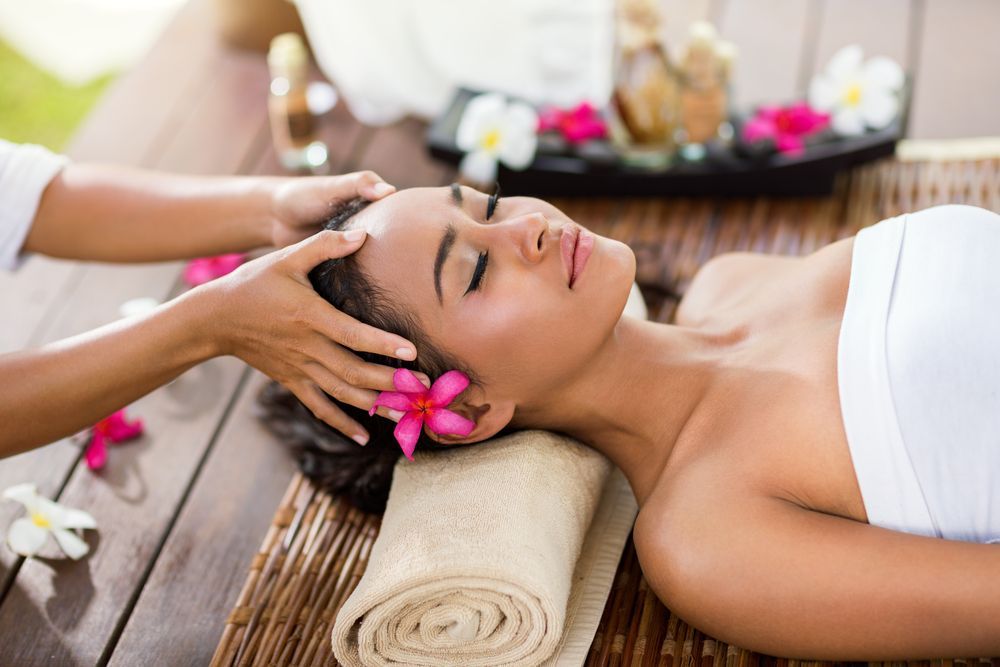 Woman Receiving a Head Massage Outdoors — Leela Thai Massage & Spa in Newtown, QLD
