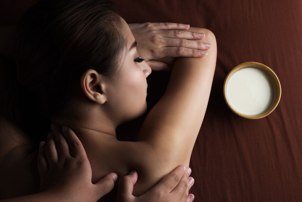 Woman Receiving a Massage, Lying on a Brown Cloth — Leela Thai Massage & Spa in Newtown, QLD