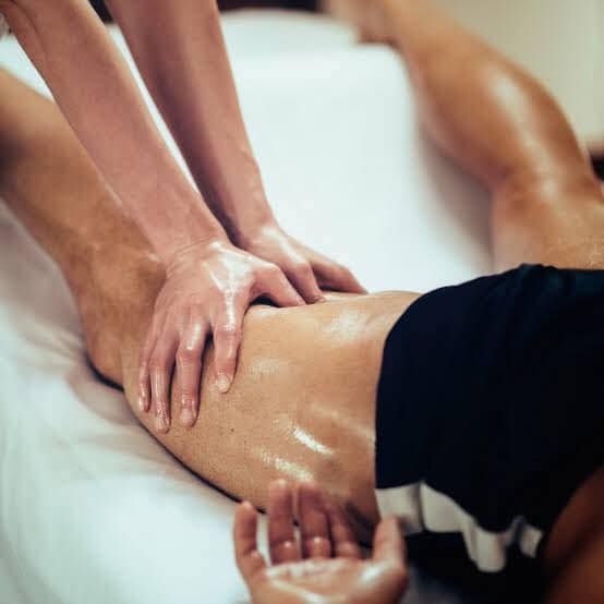 Hands Massaging a Leg on a Massage Table — Leela Thai Massage & Spa in Newtown, QLD