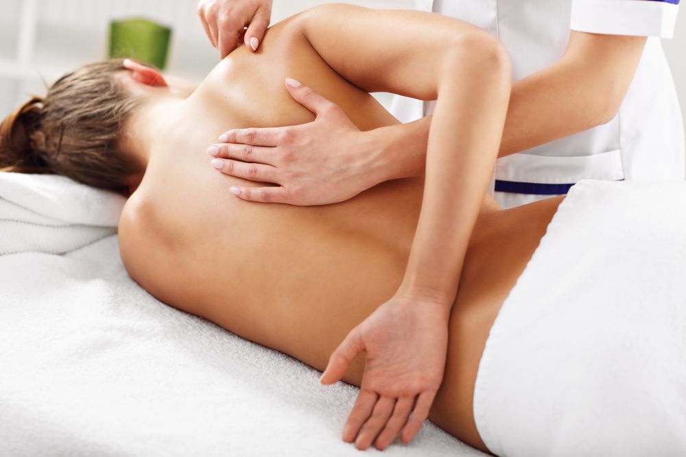 Person Receiving a Back Massage on a Massage Table — Leela Thai Massage & Spa in Newtown, QLD