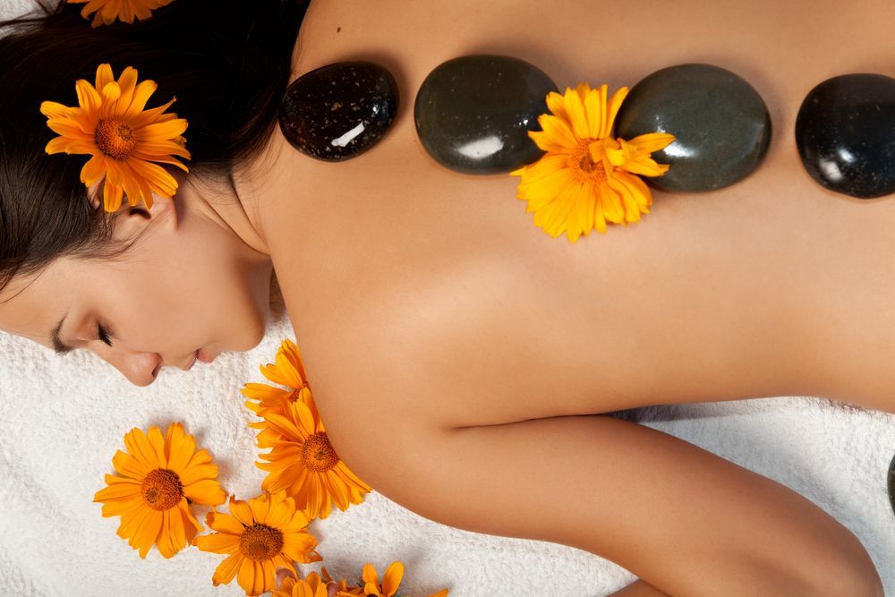 Woman Receiving Hot Stone Massage — Leela Thai Massage & Spa in Newtown, QLD