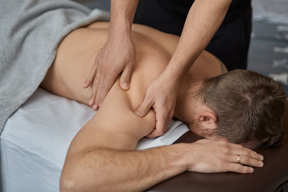 Person Receiving a Shoulder Massage From a Masseuse — Leela Thai Massage & Spa in Newtown, QLD
